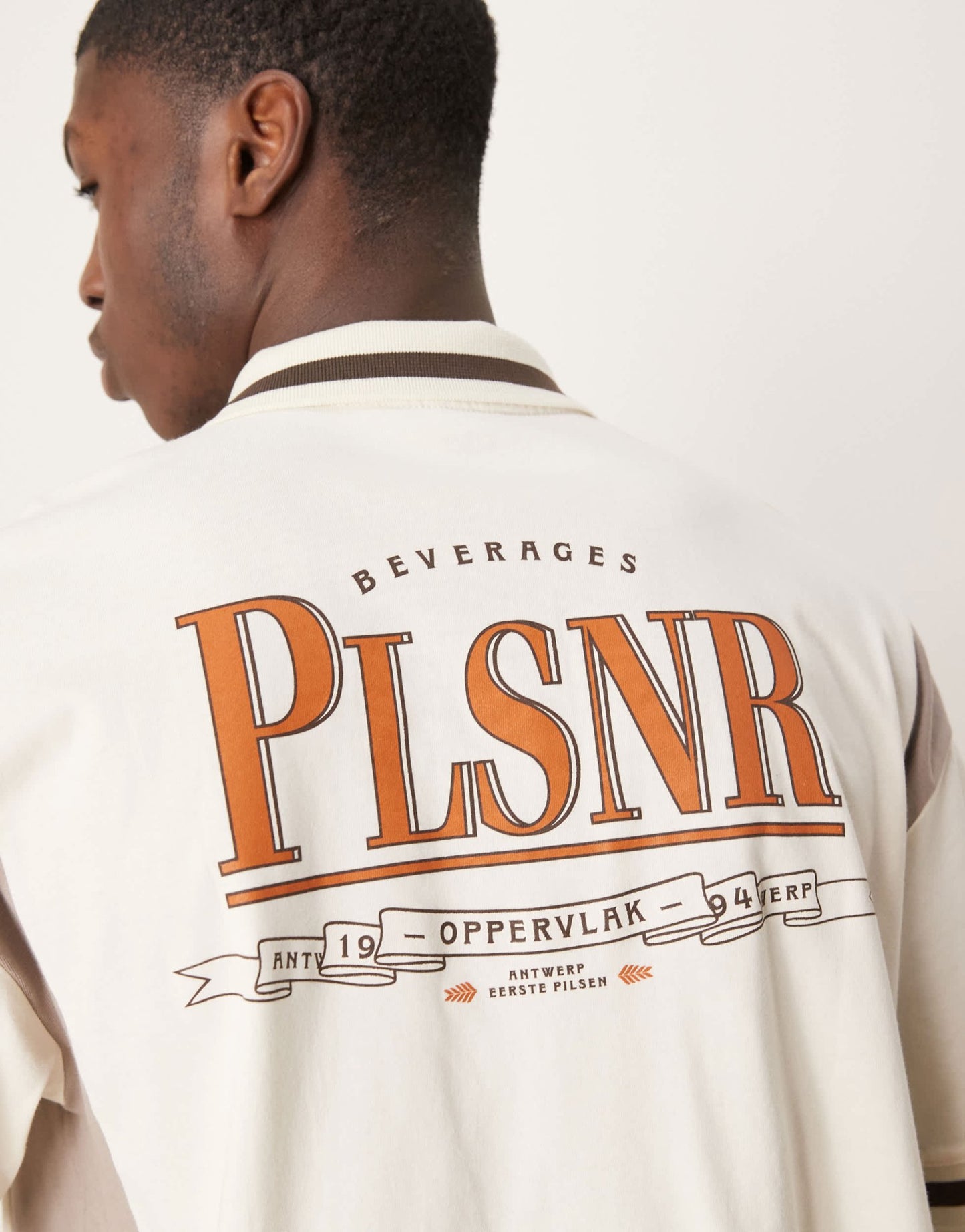 ASOS DESIGN boxy oversized zipped polo with cut and sew panelling and text graphic in cream - ASOS Sample Sale EU Store