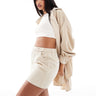 Conjunto de minifalda micro de pana con cinturón ASOS DESIGN en color crema