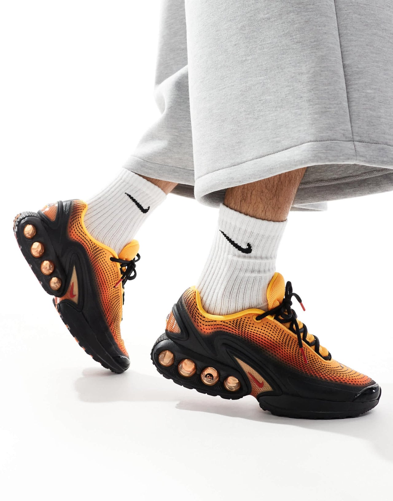 Nike Air Max DN trainers in black and orange - ASOS Sample Sale EU Store