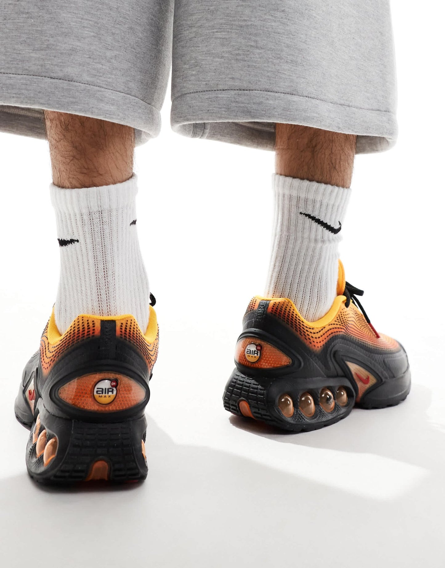 Nike Air Max DN trainers in black and orange - ASOS Sample Sale EU Store