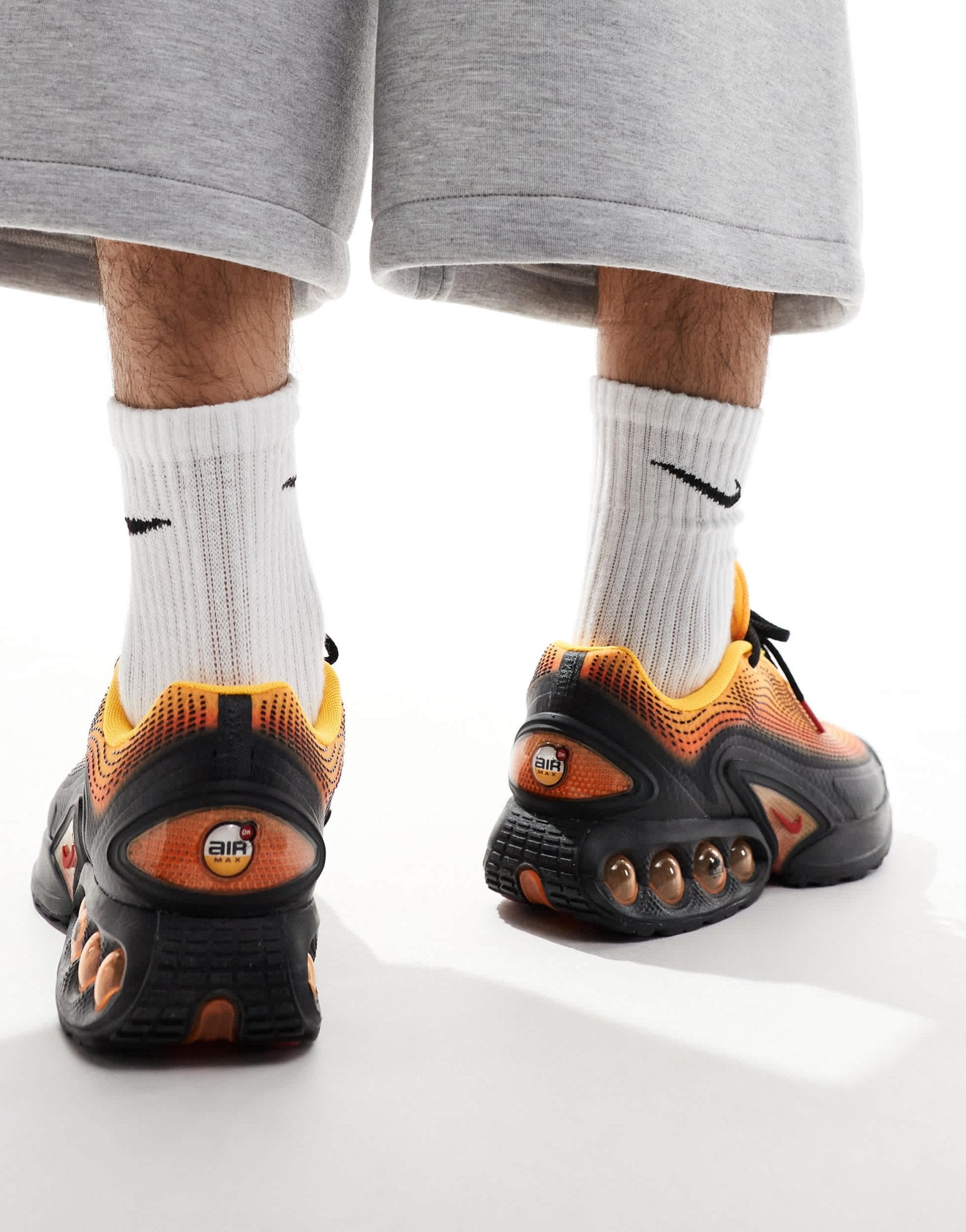 Nike Air Max DN trainers in black and orange - ASOS Sample Sale EU Store