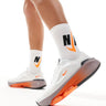 Nike Training Versair trainers in white and orange